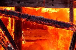 Fallen House Beams Engulfed in Flame