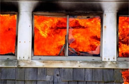 Structure Filled with Fire Inside Seen Through Window